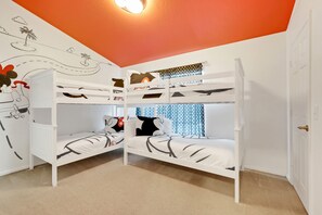 A room with bunk beds, a mural, and a window with curtains. - Disney Min Away - Pool Patio Playground (Kissimmee)