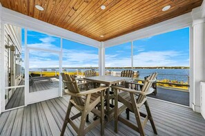 A covered outdoor dining area with a view of the water. - Waterfront Views - Walk to Beach - Heated Pool (Gulf Shores)