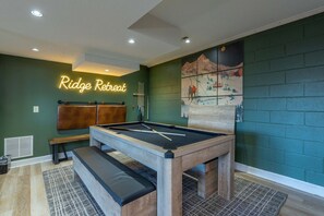 A pool table with a neon sign reading 'Ridge Retreat' in a room with green walls and a mural. - Min to Hatley Mountain Views-hot Tub-game Room (Mars Hill)