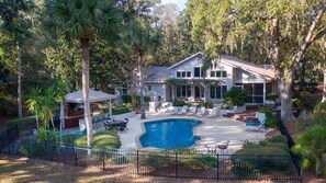 A residential property with a swimming pool, outdoor seating, and a covered patio area. - Vacation Paradise - Private Pool Fire Pit BBQ (Hilton Head Island)