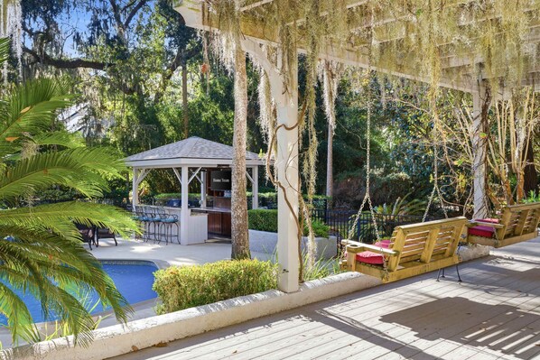 A wooden deck with a pool, a gazebo, and outdoor seating. - Vacation Paradise - Private Pool Fire Pit BBQ (Hilton Head Island)