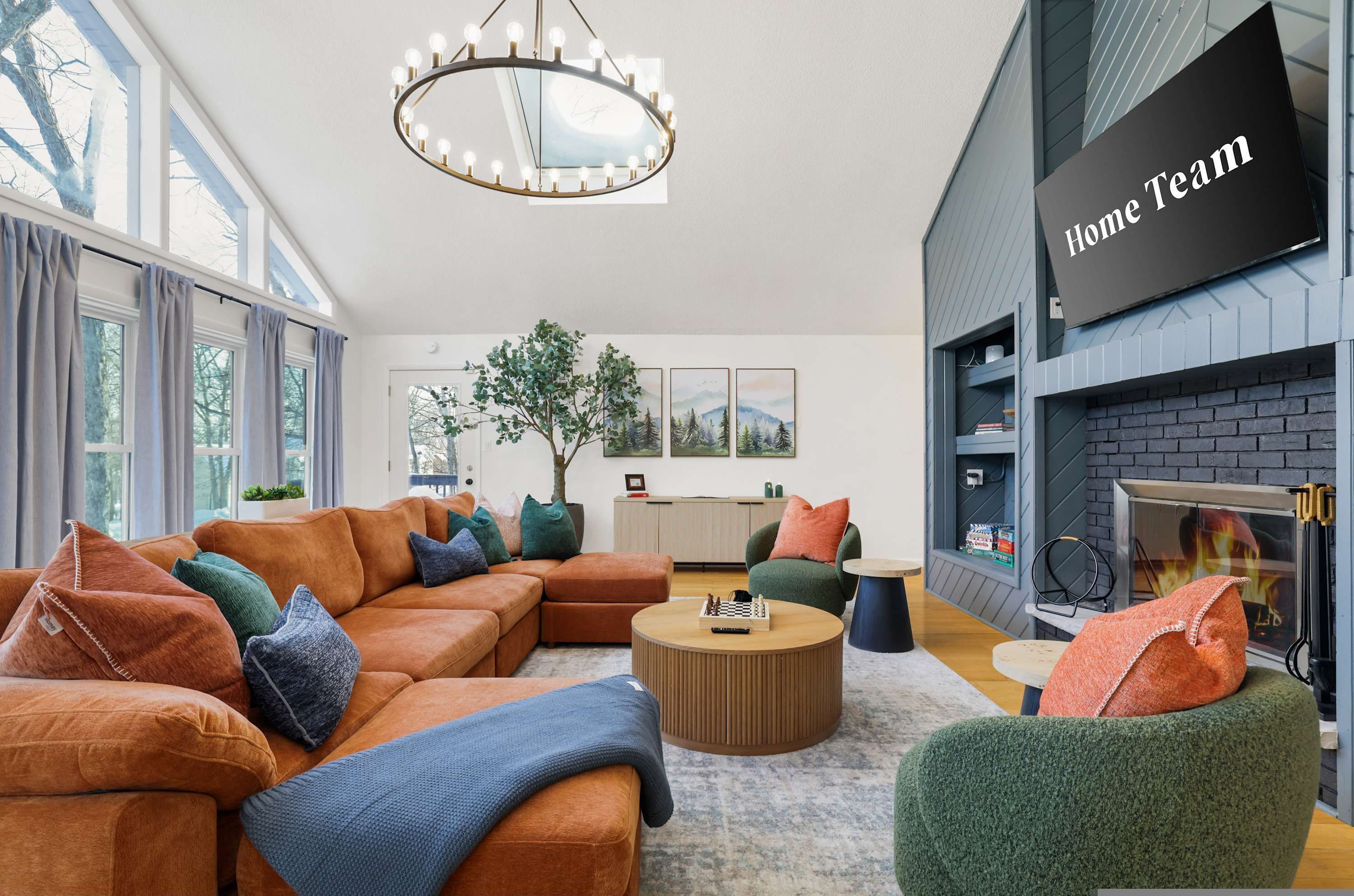 A modern living room with a sectional sofa, a round coffee table, and a fireplace.