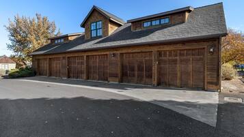 A two-story building with a garage and a covered driveway.