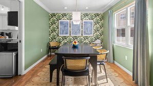 A dining area with a table, chairs, and a fruit bowl. - 4 Minutes to Beach Pool Hot Tub Game Room (Seminole)