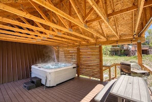 A hot tub under a wooden pergola with a wooden deck and outdoor furniture. - Ski-lee Retreat Ski Hike Explore Sleeps 10 (Brian Head)