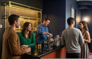 A bar area with a bartender preparing drinks, a counter, and a group of people standing around. - 6k Sqft Estate - Epic Amenities Fun - Sleeps 22 (San Antonio)
