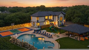 A residential property with a swimming pool, basketball court, and a children's play area. - 6k Sqft Estate - Epic Amenities Fun - Sleeps 22 (San Antonio)