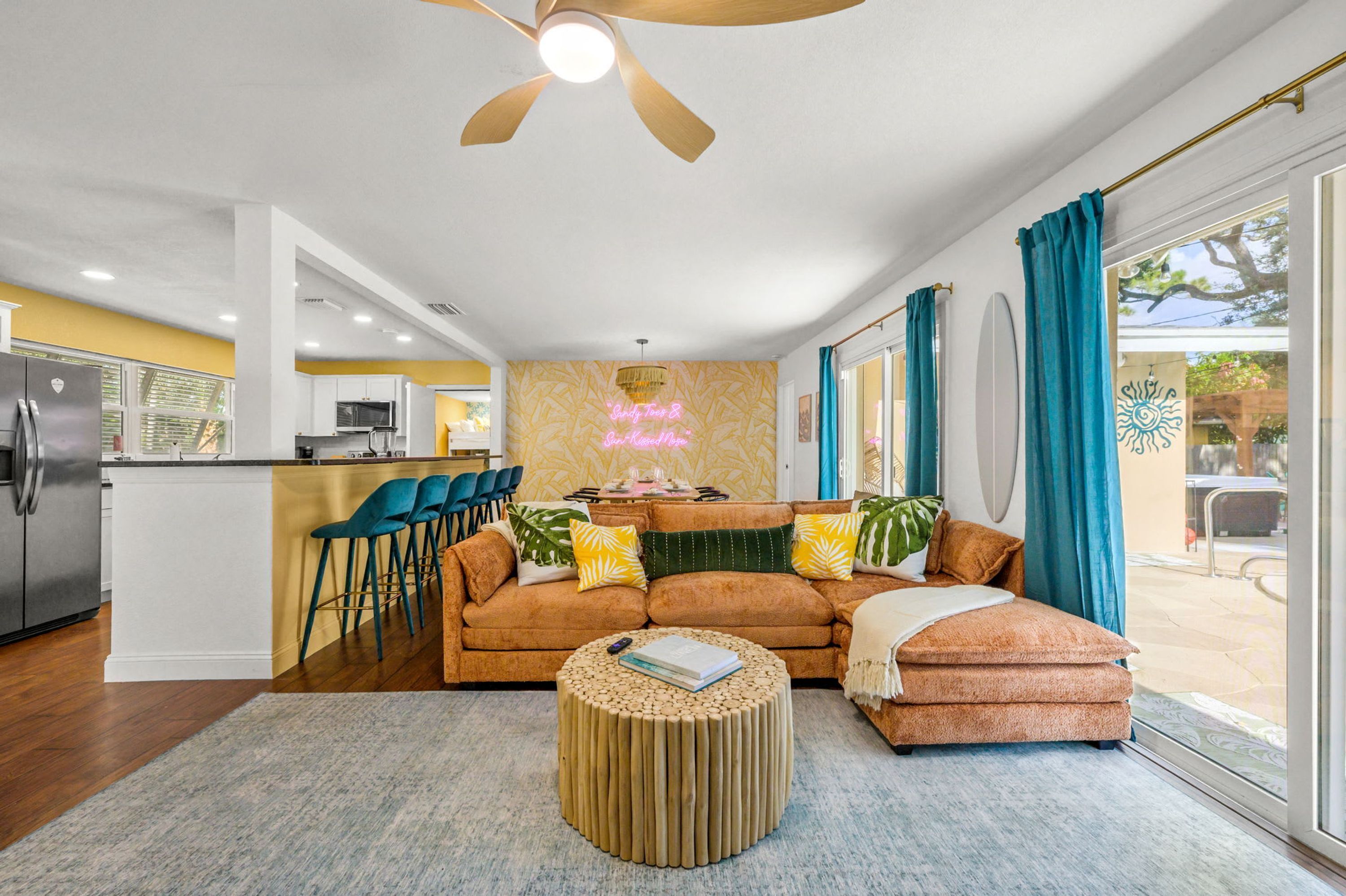 A modern living room with a sofa, coffee table, and a ceiling fan.
