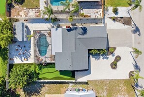 An aerial view of a property with a swimming pool, a covered patio area, and a landscaped garden. - Poolside Oasis Sleeps 8 Game Room Putt Putt (Bradenton)