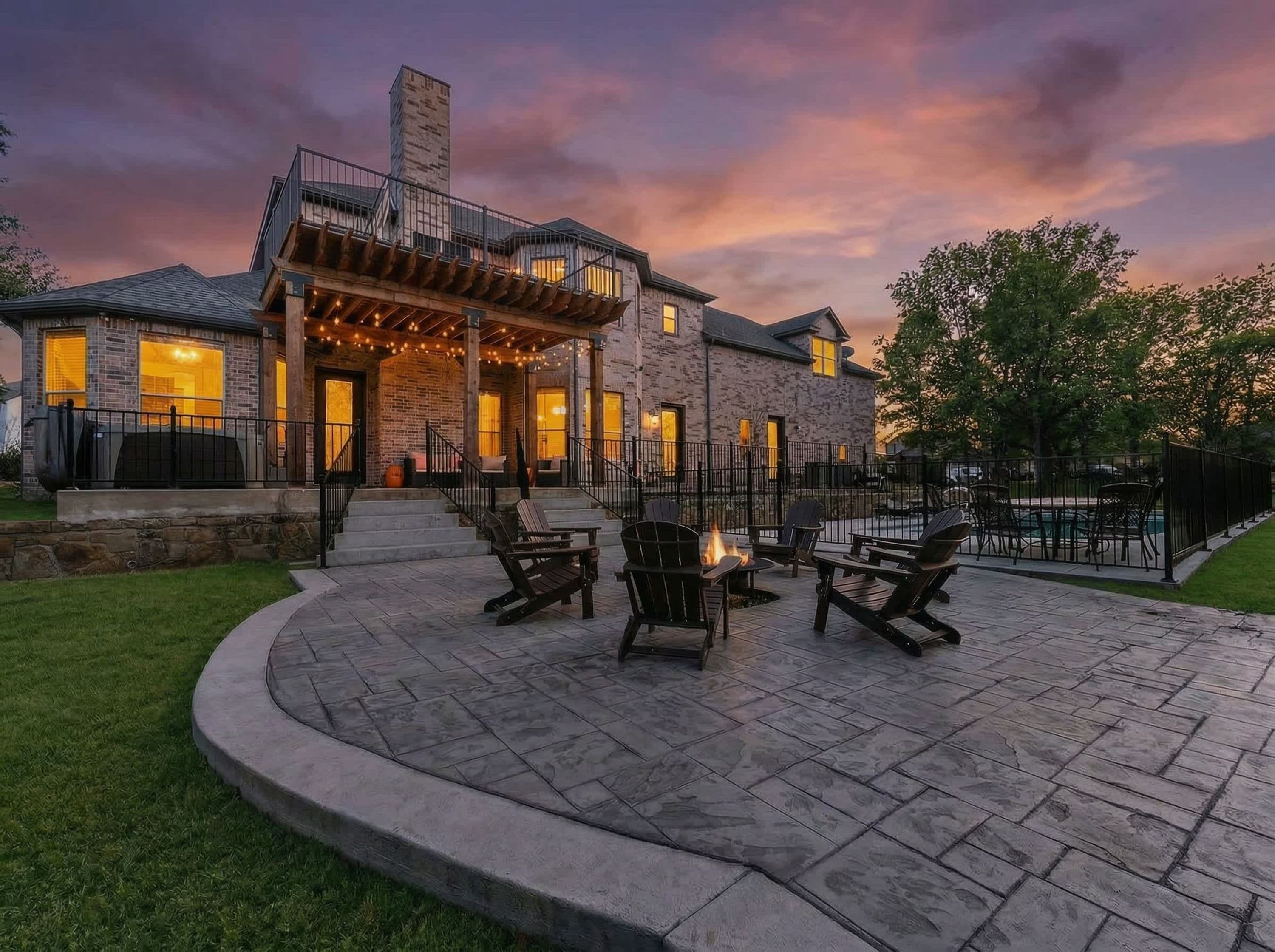 A stone patio with outdoor seating and a fire pit.