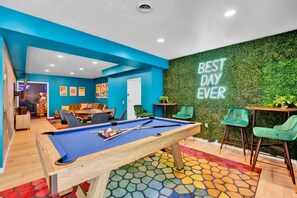 A pool table with a colorful mosaic floor, a green wall with a 'BEST DAY EVER' sign, and a billiards setup. - Sleeps 14 Pool Hot Tub Sauna Pickleball Arcade (Stroudsburg)
