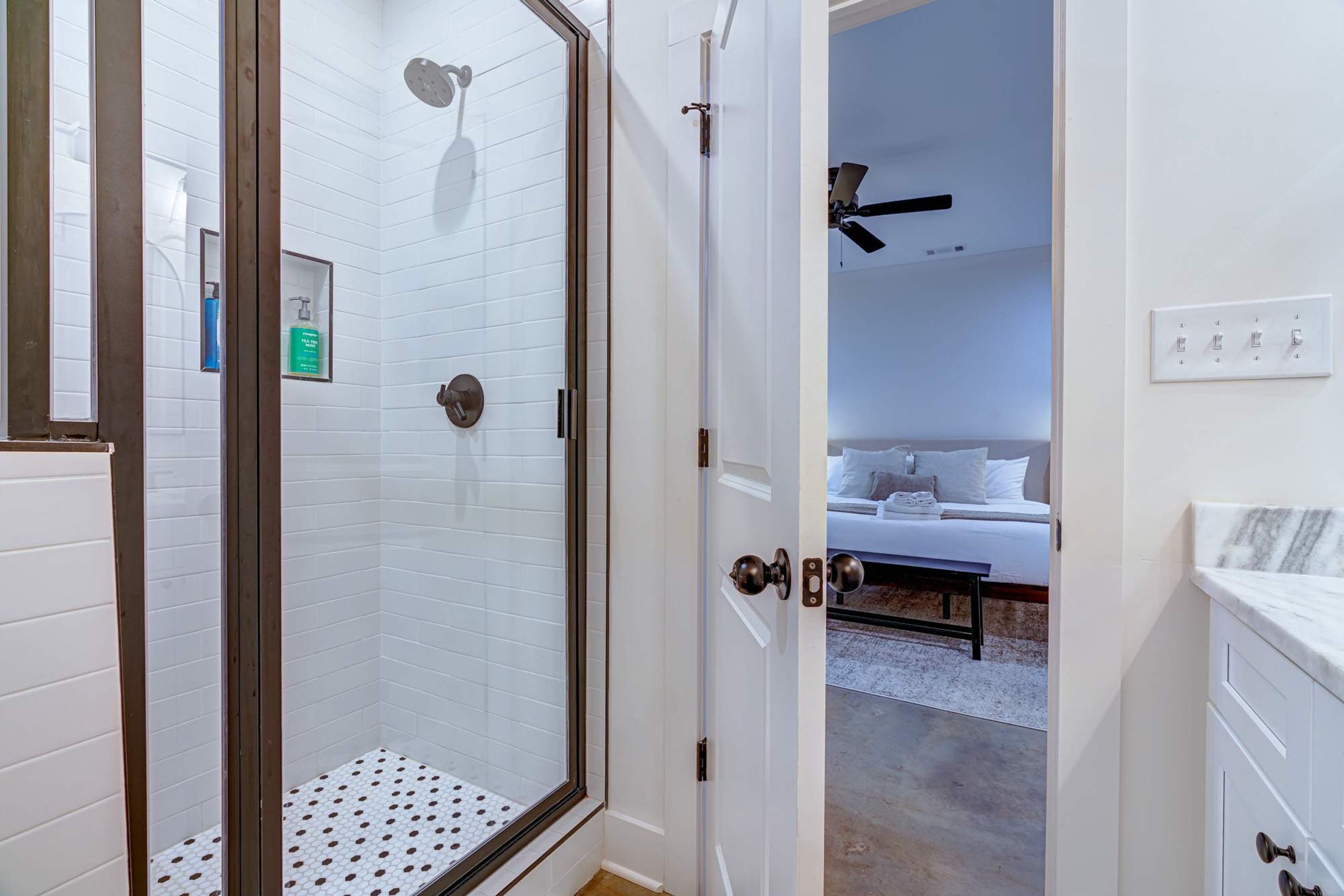 A hotel bathroom with a shower, a toilet, and a sink.
