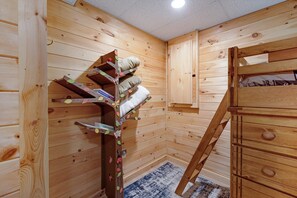 A wooden interior with a bunk bed, a small bookshelf, and a cabinet. - Mountain Views w Slide Hot Tub Game Room (Mineral Bluff)