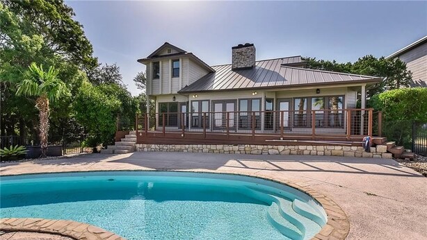 Una casa de dos pisos con piscina.