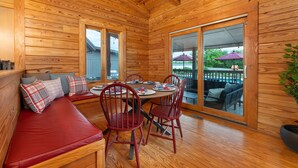 A wooden interior with a dining table, red chairs, and a bench with cushions. - 7 Br Sleeps 20 Sport Court Pool Hot Tub Playground (Arden)