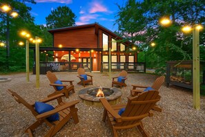 A wooden deck with outdoor seating and a fire pit. - Sleeps 6 Sauna Hot Tub Putt Putt Dogs Welcome (Broken Bow)