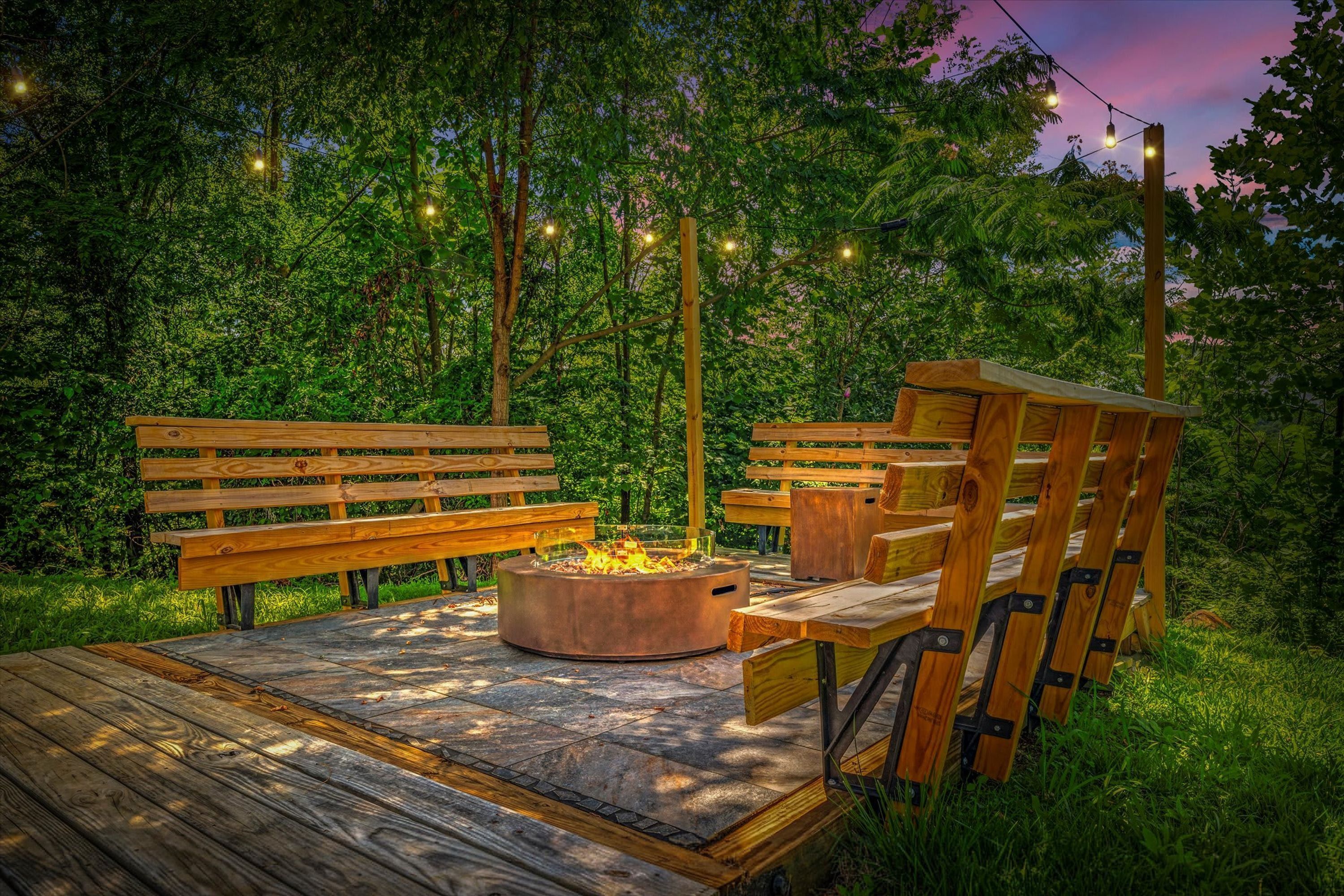 An outdoor seating area with wooden benches and a fire pit.