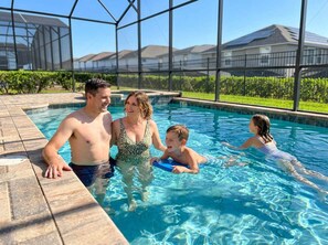 Une piscine offrant une vue dégagée sur le paysage environnant, notamment sur les maisons et la végétation.
