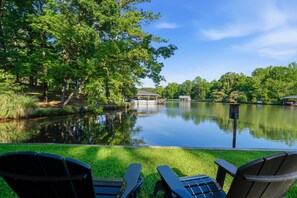A tranquil lakeside setting with a dock, chairs, and a gazebo. - The Sinclair House Private Lake Retreat (Milledgeville)