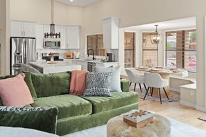 A modern kitchen with white cabinets, a stainless steel refrigerator, and a microwave. - The Ultimate Stay Play Retreat 4BR Sleeps 13 (Chandler)