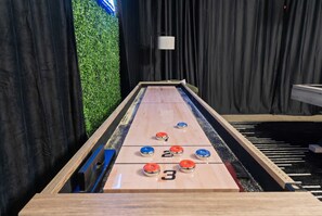 A shuffleboard table with numbered scoring areas and pucks. - The Ultimate Stay Play Retreat 4BR Sleeps 13 (Chandler)