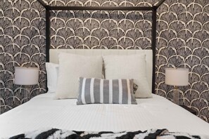 A bedroom with a canopy bed, two bedside lamps, and patterned wallpaper. - The Ultimate Stay Play Retreat 4BR Sleeps 13 (Chandler)