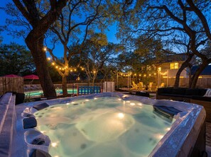 A hot tub surrounded by trees and outdoor seating. - Sleeps 14 Pool Hot Tub Near Airport (San Antonio)