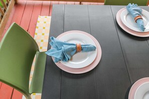 A table set with plates, napkins, and a placemat. - Austin Encore Pool Hot Tub Putt-putt (Austin)