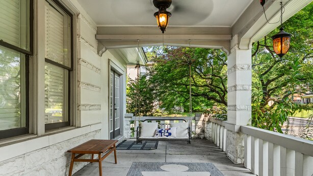 A covered porch with a bench, a swing, and a decorative rug. - 6BR Home Private Pool Spa Games Gazebo (Memphis)