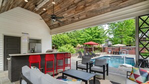 An outdoor patio with a pool, seating, and a barbecue area. - 6BR Home Private Pool Spa Games Gazebo (Memphis)
