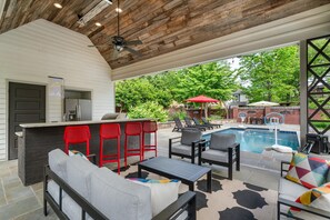 An outdoor patio with a pool, seating, and a barbecue area. - 6BR Home Private Pool Spa Games Gazebo (Memphis)