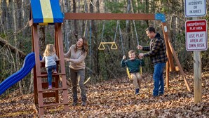 A playground with a swing set, a slide, and a warning sign about unsupervised play. - Cozy Cabin in Mountains Firepit Views Games (Sautee Nacoochee)