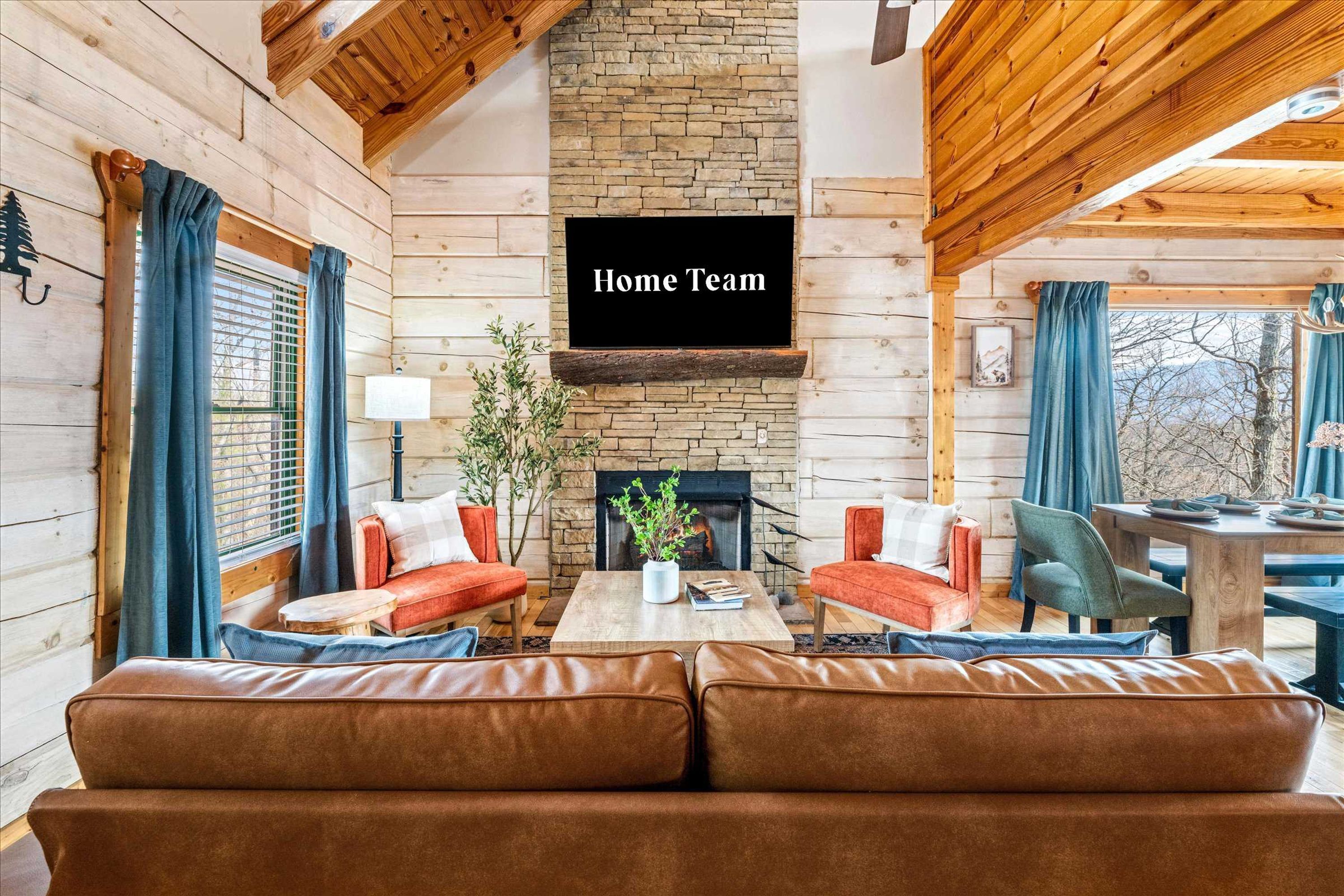 A cozy log cabin interior with a fireplace, a sofa set, and a dining table.