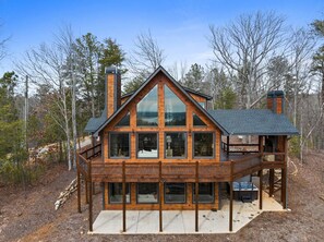 A modern log cabin with a large deck, multiple windows, and a chimney. - Epic Mountain Views Hot Tub Games and Firepit (Ellijay)