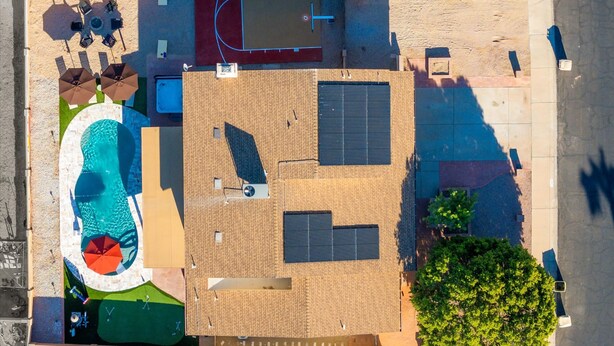 An aerial view of a property with a swimming pool, tennis court, and a covered patio area. - Epic Family Getaway Speakeasy Pool Basketball (Glendale)