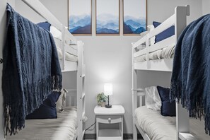 A bunk bed room with a small table and a lamp, featuring a mountain view. - Sleeps 16 Hot Tub Arcade Resort Amenities (Albrightsville)