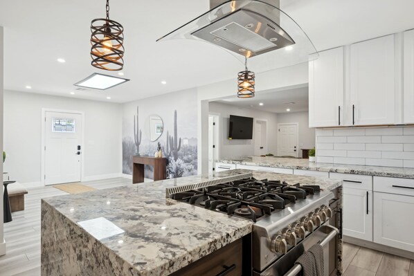 A modern kitchen with a central island, stainless steel appliances, and pendant lighting. - Casa Mesa Private Paradise w Pool Putt Games (Mesa)