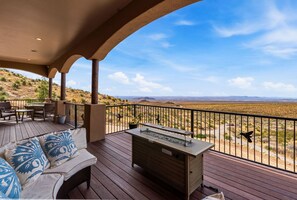 A covered outdoor area with a wooden deck, seating, and a barbecue station. - Private Estate Pool Views Events Welcome (Las Cruces)