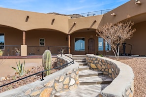 A building with a curved stone staircase, a cactus, and a tree in the courtyard. - Private Estate Pool Views Events Welcome (Las Cruces)