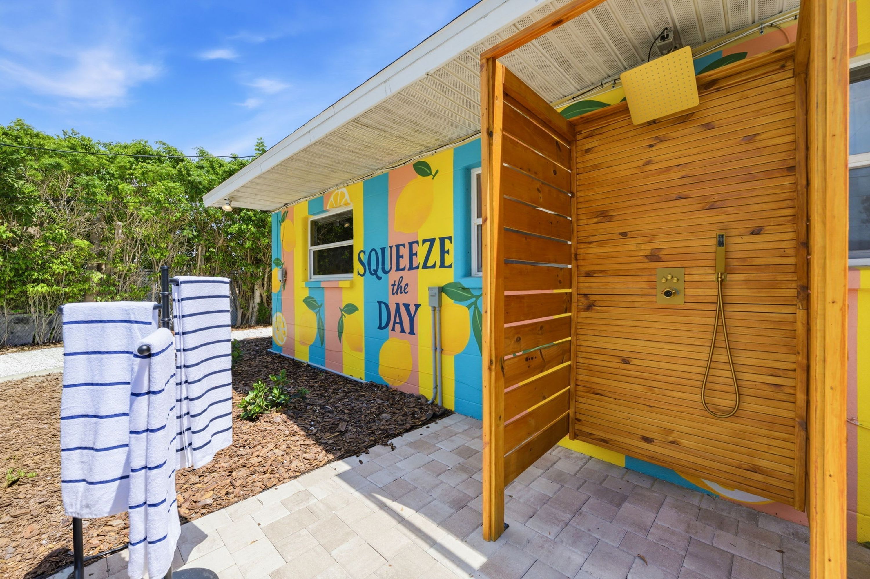 A colorful building with a wooden door and a sign that reads 'SQUEEZE the DAY'.