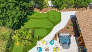 A golf course with a hot tub and lounge chairs. - Bradenton Vacation Haven Pool Hot Tub Arcade (Bradenton)