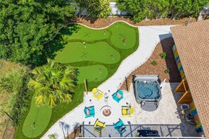 A golf course with a hot tub and lounge chairs. - Bradenton Vacation Haven Pool Hot Tub Arcade (Bradenton)