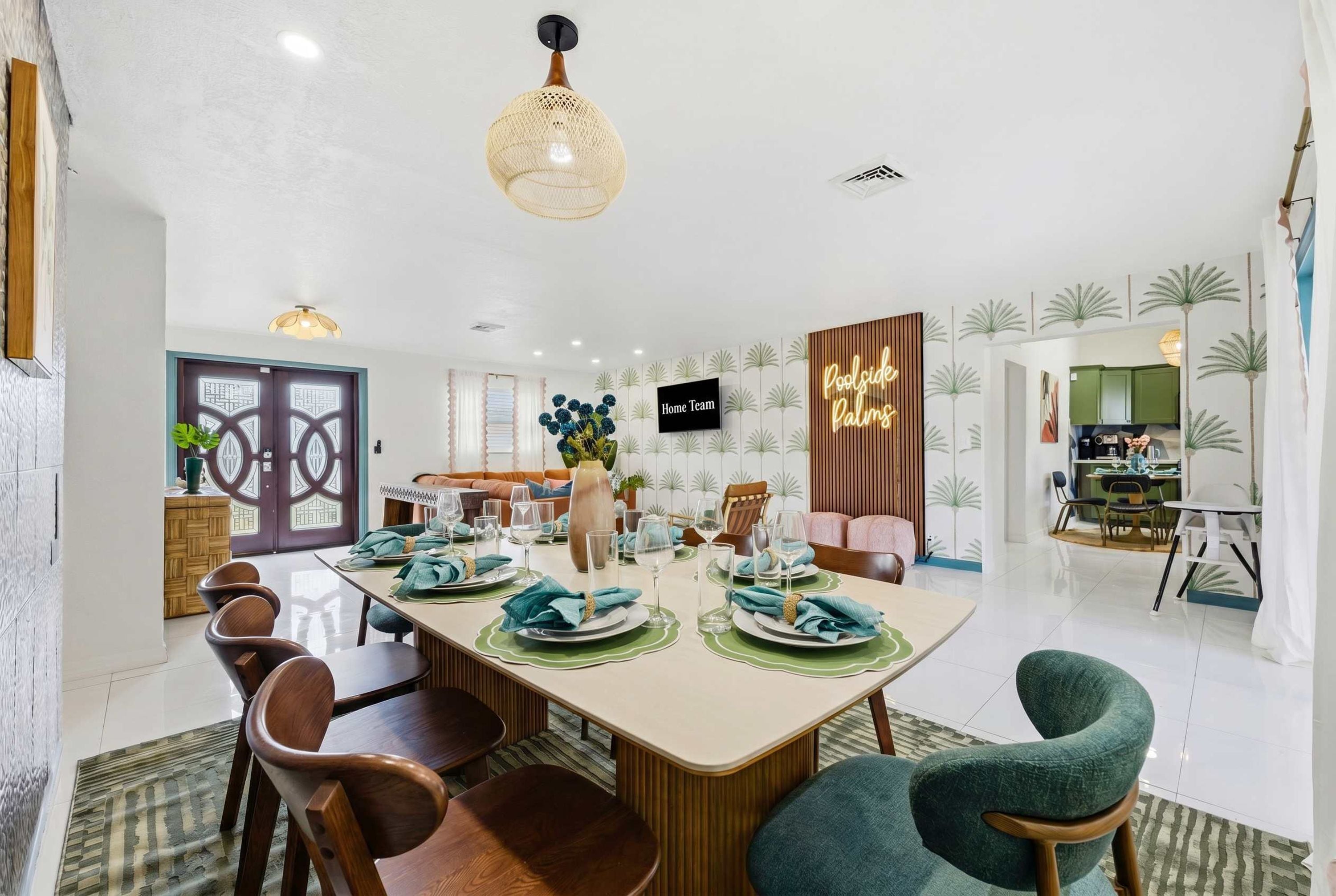 A dining area with a long table set for six, surrounded by wooden chairs.