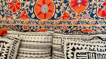 A collection of intricately patterned textiles, likely used for upholstery or decoration.