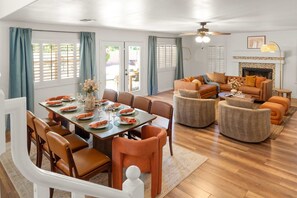 A dining area with a table set for six, surrounded by chairs. - Desert Daze A Fun-filled 5BR Retreat Sleeps 12 (Mesa)
