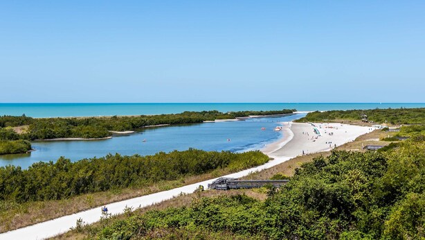 A coastal landscape with a beach, a clear sky, and a waterway. - Marco Island Escape Pool Game Room (Marco Island)