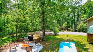 A backyard with a fire pit, seating, and a hammock. - Secluded Escape Fire Pit Gazebo Dog Welcome (Blue Ridge)