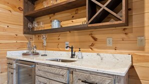 A kitchen with a wooden countertop, a sink, and a built-in wine rack above it. - Stunning Views Sleeps 10 - Hot Tub - 2 Fireplaces (Blue Ridge)