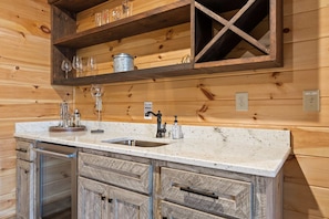 A kitchen with a wooden countertop, a sink, and a built-in wine rack above it. - Stunning Views Sleeps 10 - Hot Tub - 2 Fireplaces (Blue Ridge)