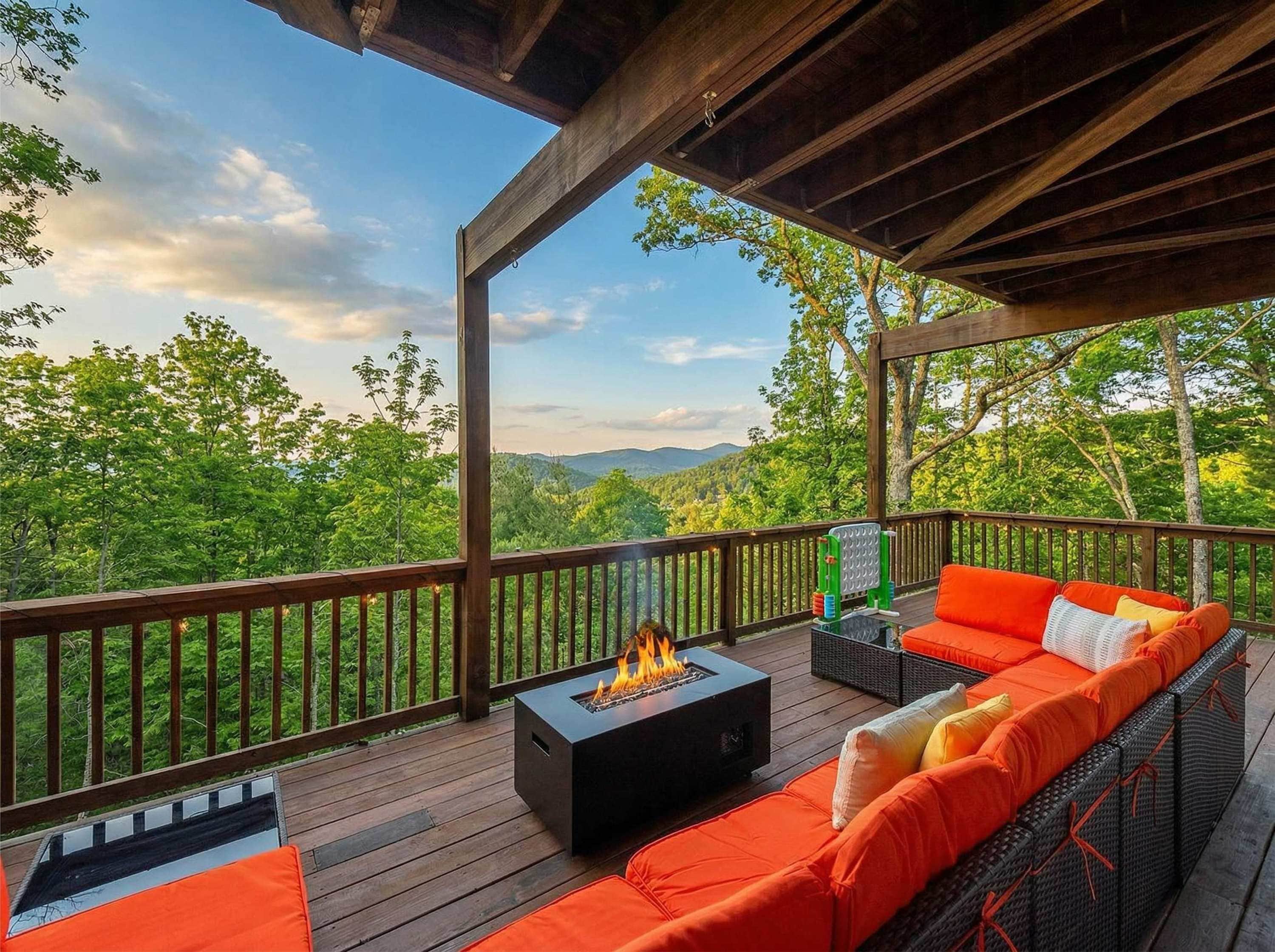 A deck with a fire pit, outdoor furniture, and a view of a forested landscape.
